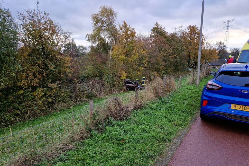 Auto rolt van de dijk af