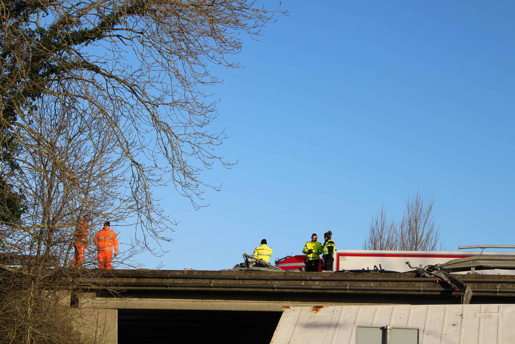 Vrachtwagen rijdt van snelweg af en plet bestelbus