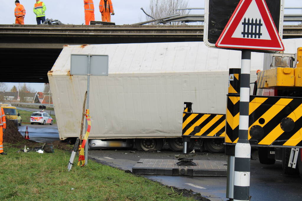 Vrachtwagen rijdt van snelweg af en plet bestelbus