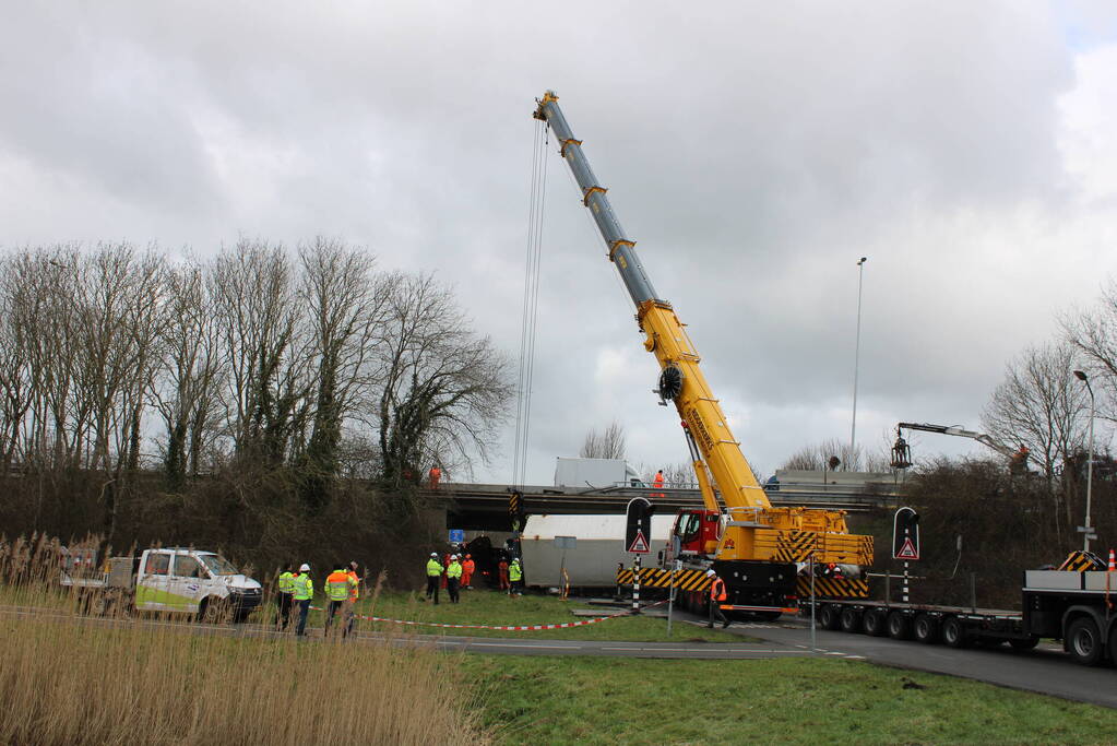 Vrachtwagen rijdt van snelweg af en plet bestelbus