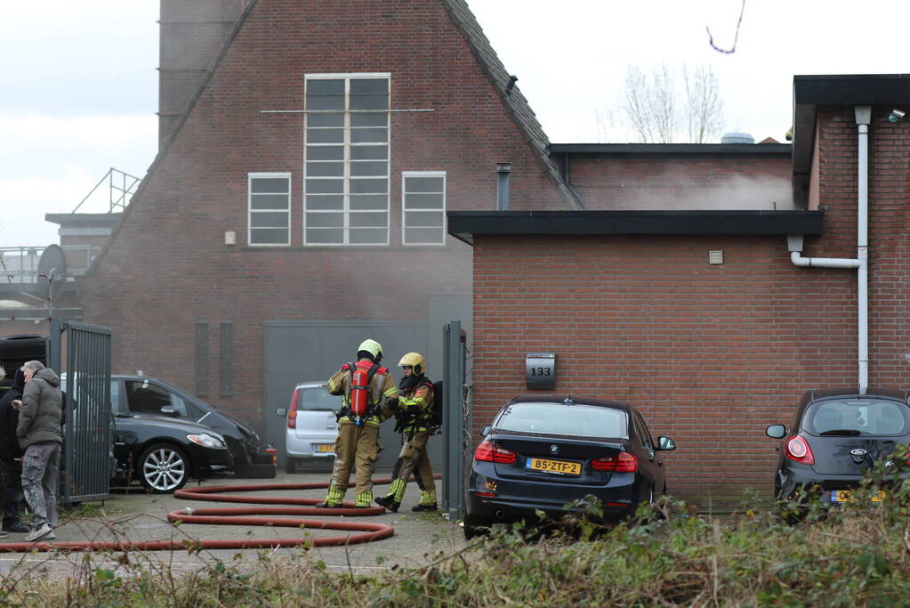 Auto vliegt in spuitcabine in brand