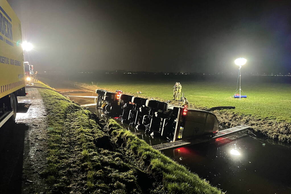 Vrachtwagen belandt op zijn kant in sloot