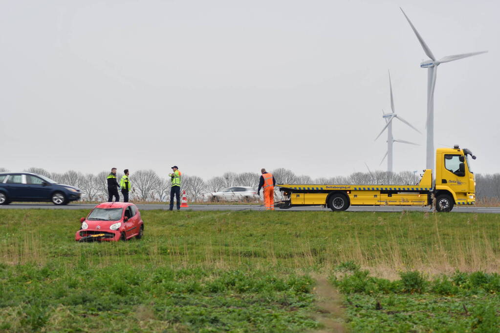 Auto belandt op zijn kop naast snelweg
