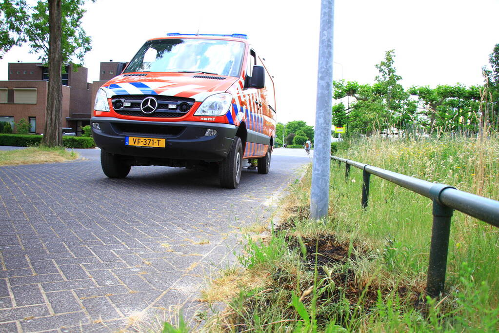 Berm in brand bij winkelcentrum