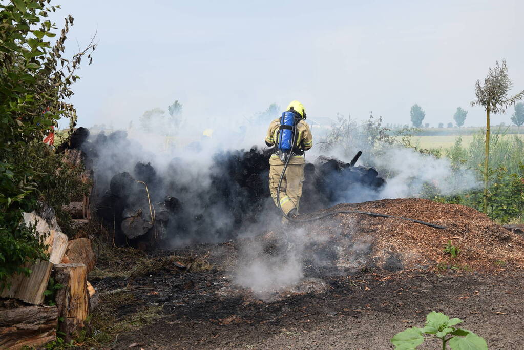 Hevige brand in stapel met houtblokken en snippers