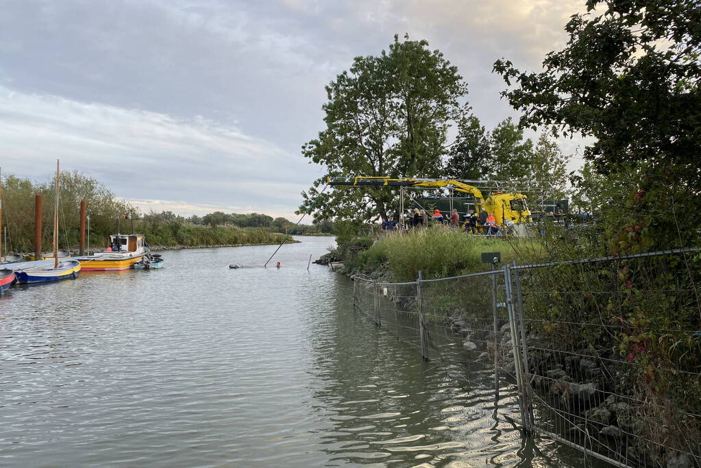 Auto en trailer verdwijnen volledig onder water