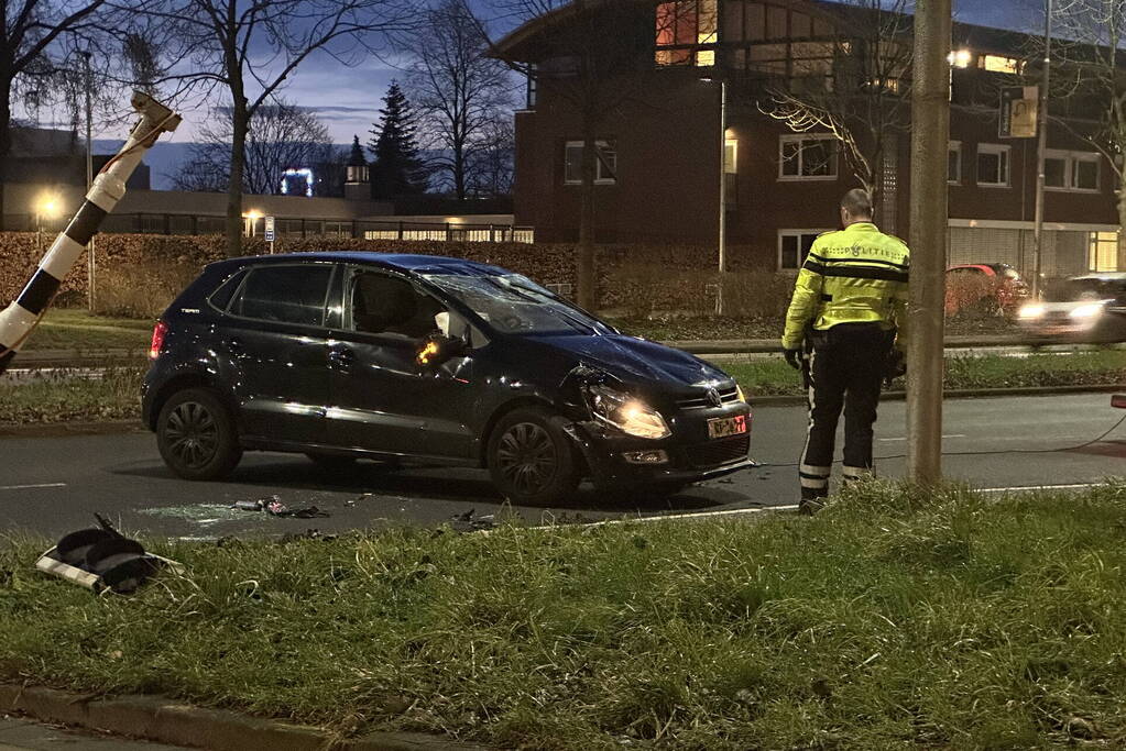 Auto knalt op verkeerslichten en slaat over de kop