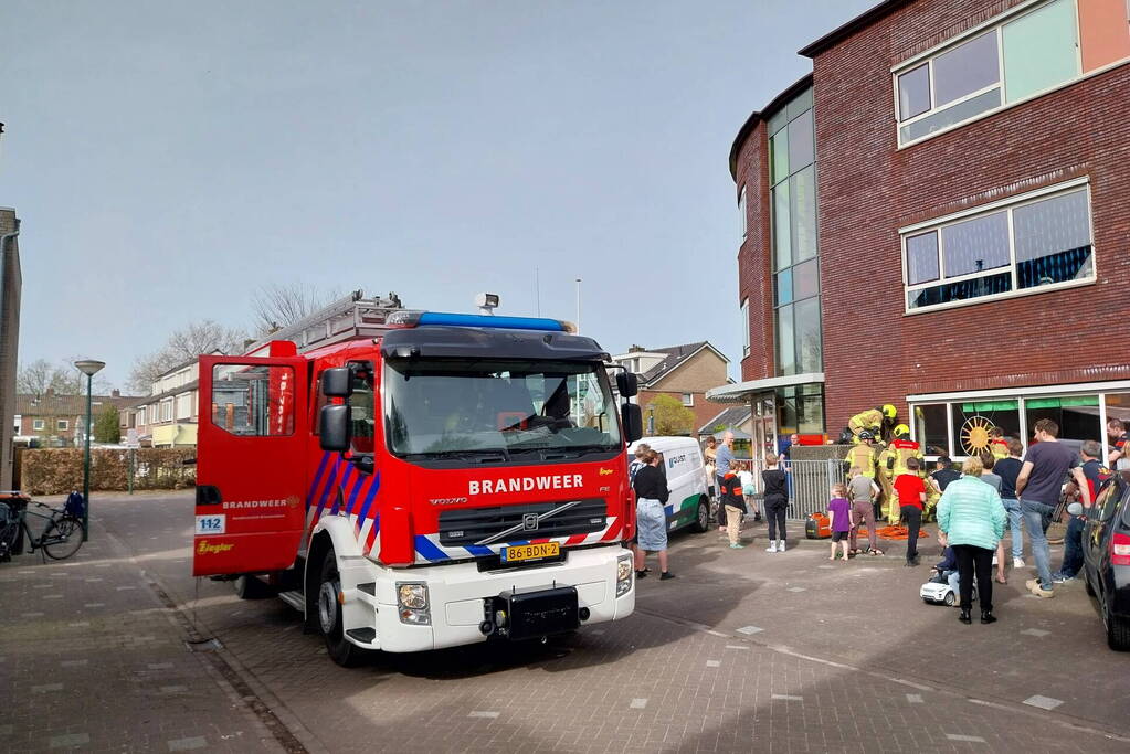 Kind bekneld tussen hek en betonnen container