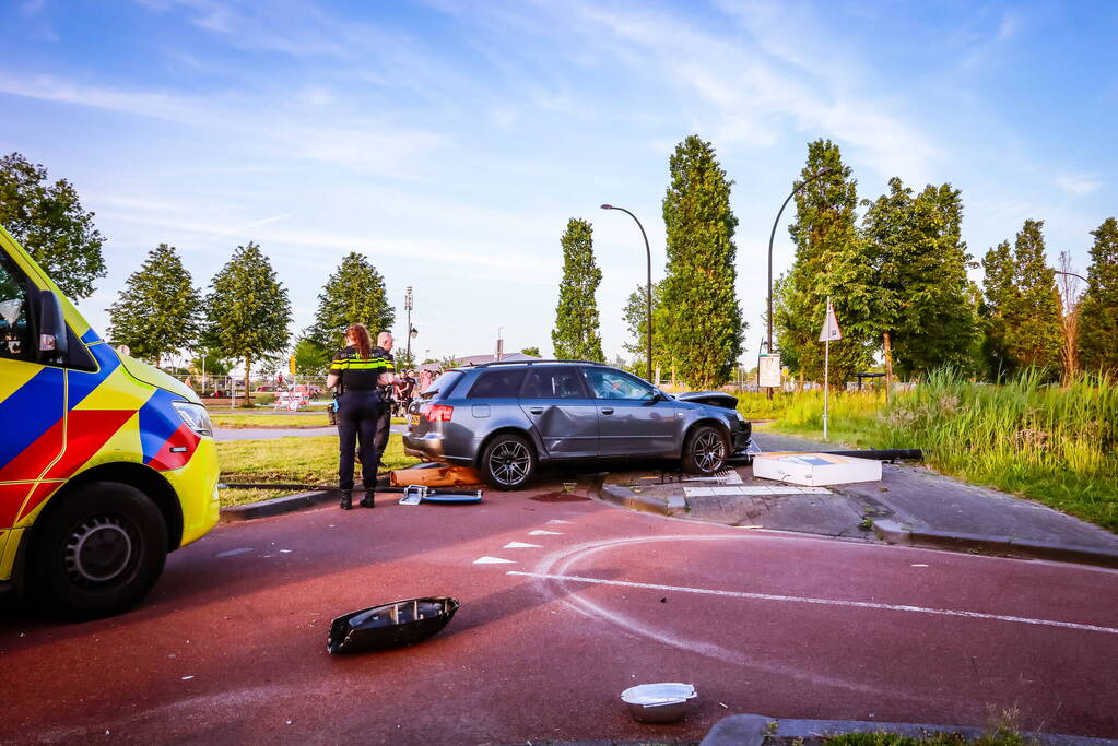 Automobilist vliegt over de rotonde botst op lantaarnpaal
