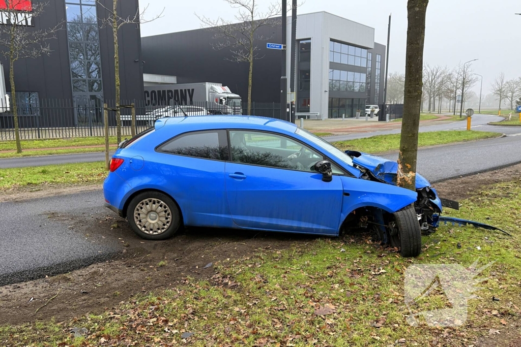 Auto knalt tegen boom in bocht