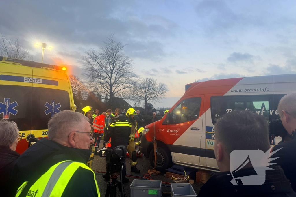 Fietser vast onder buurtbus