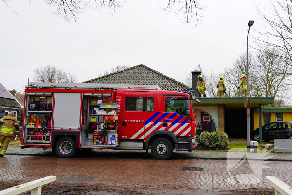 Brand in schoorsteen van fotowinkel