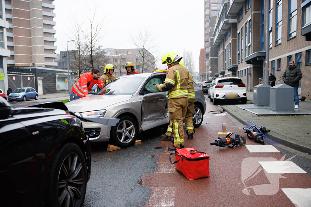 Vrouw bekneld na botsing tussen twee auto's