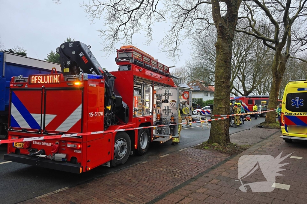 Auto belandt op zijn kant na botsing tegen boom