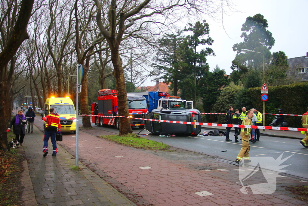 Auto belandt op zijn kant na botsing tegen boom
