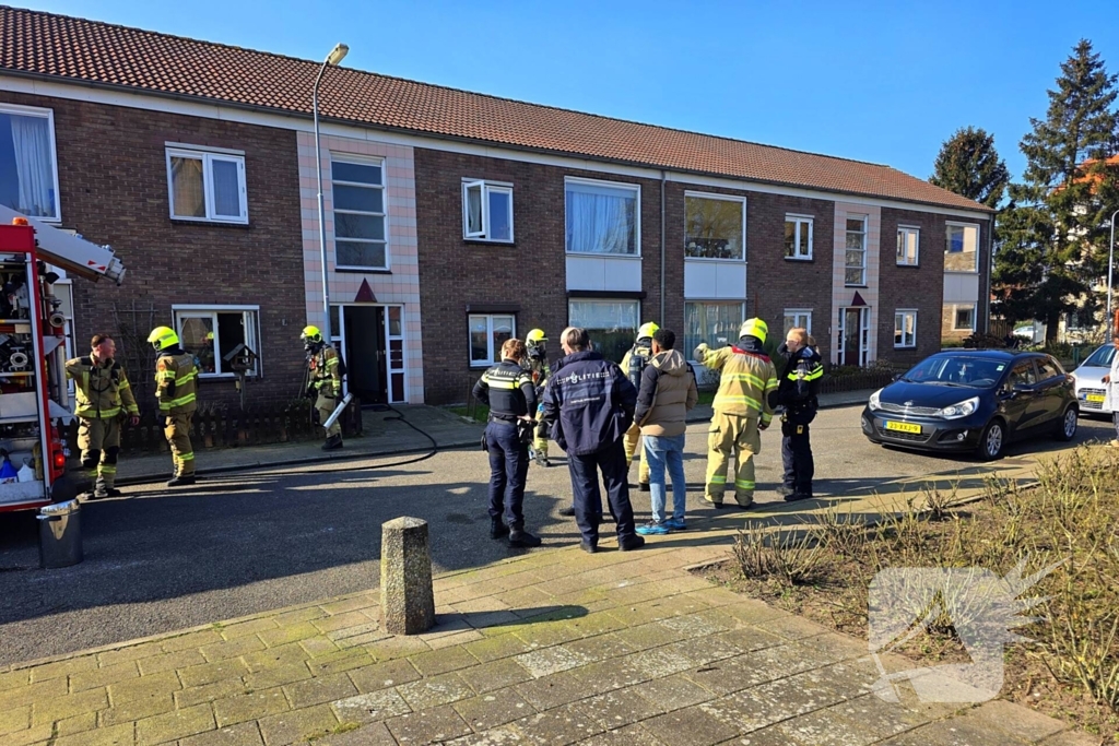 Melding van brand in portiekwoning
