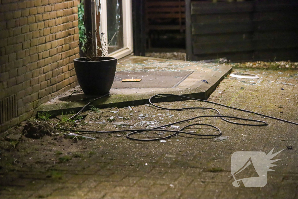 Explosie bij portiek van flatgebouw, brandweer blust vuurhaard