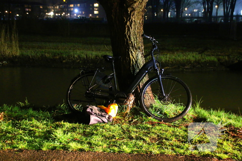 Man op fiets raakt te water