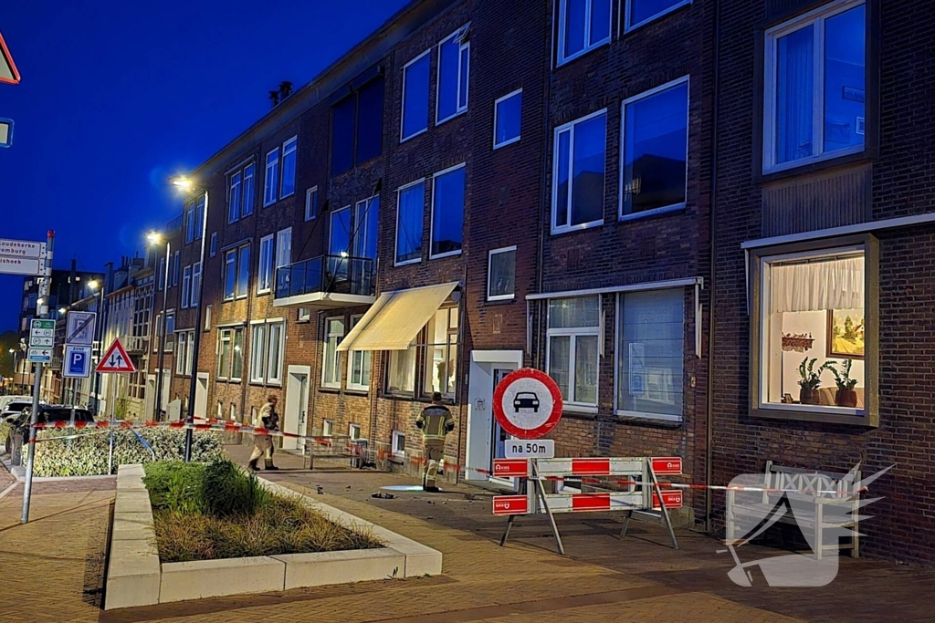 Brokstukken op stoep van gevel