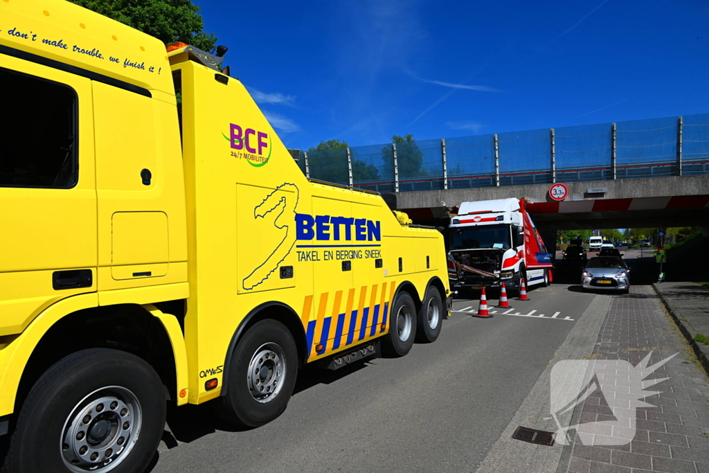 Veel schade nadat vrachtwagen klem raakt onder viaduct
