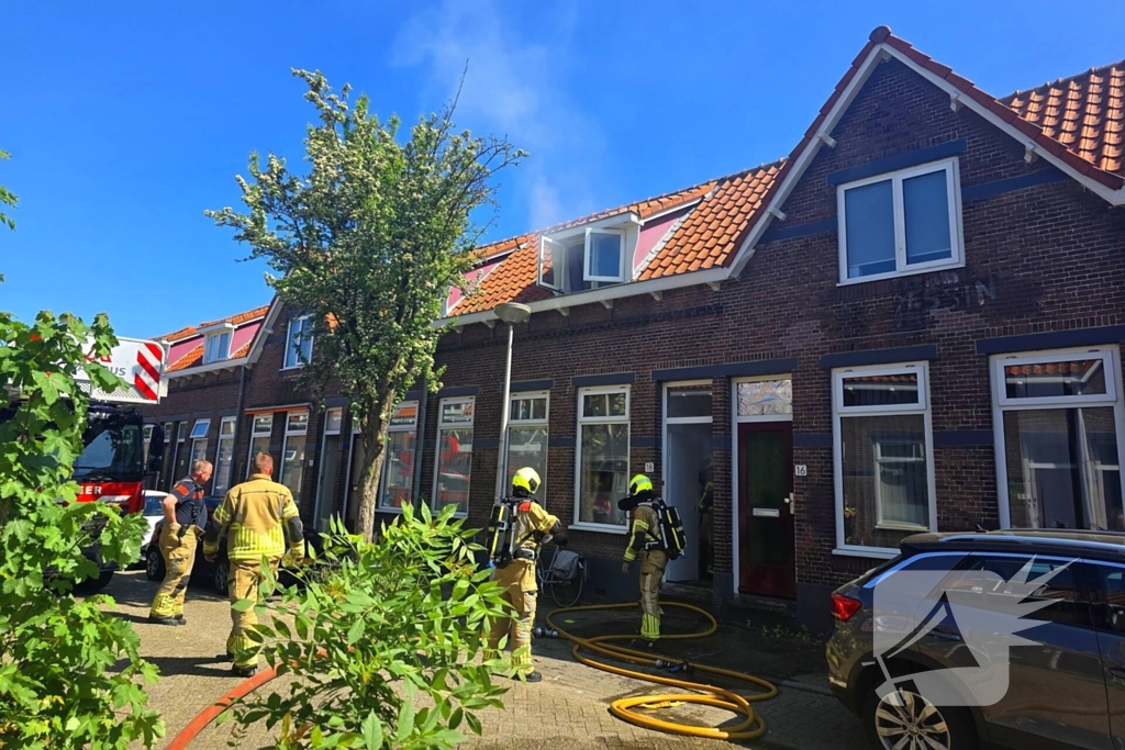 Brandweer slaat raam in wegens brand