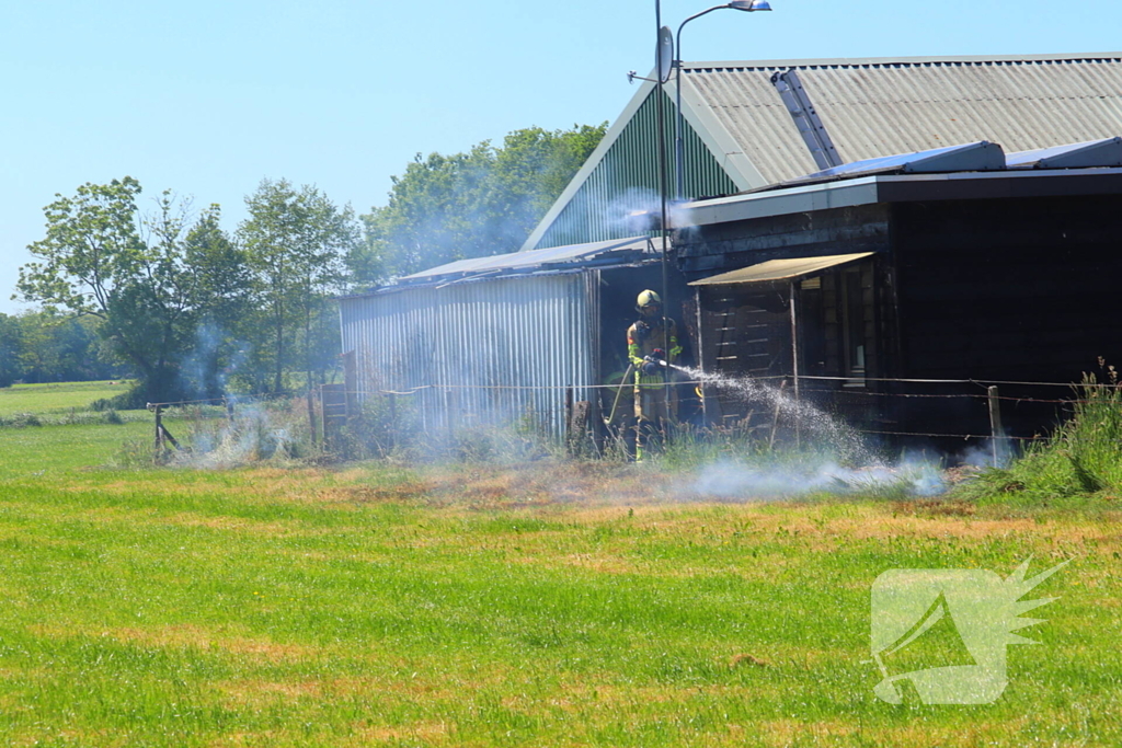 Brand in bosschage slaat over op gebouw