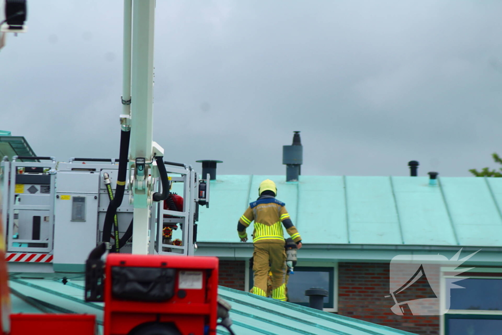 Rook uit dak van schoolgebouw