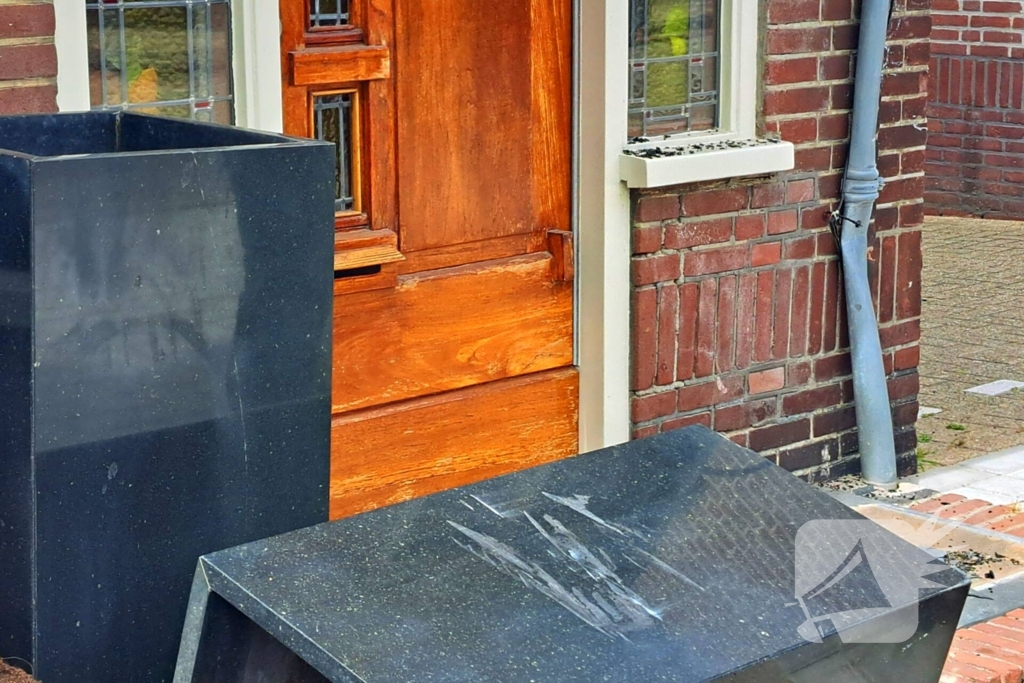 Auto rijdt achteruit tegen woning