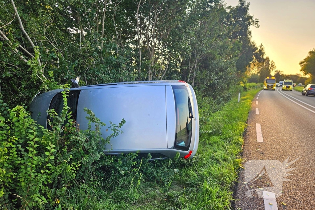 Auto kantelt in bosschages