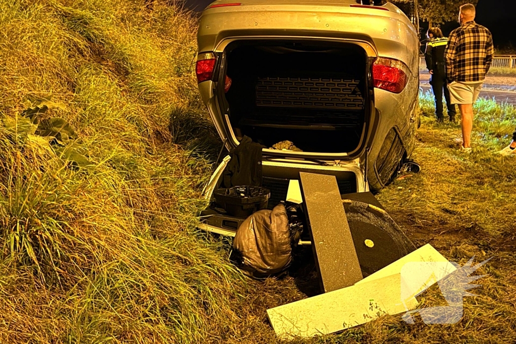 Auto belandt op kop in talud na ongeval