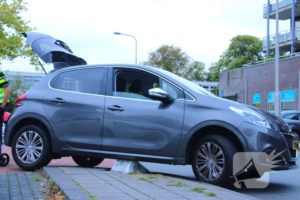 Automobilist vast op betonblok