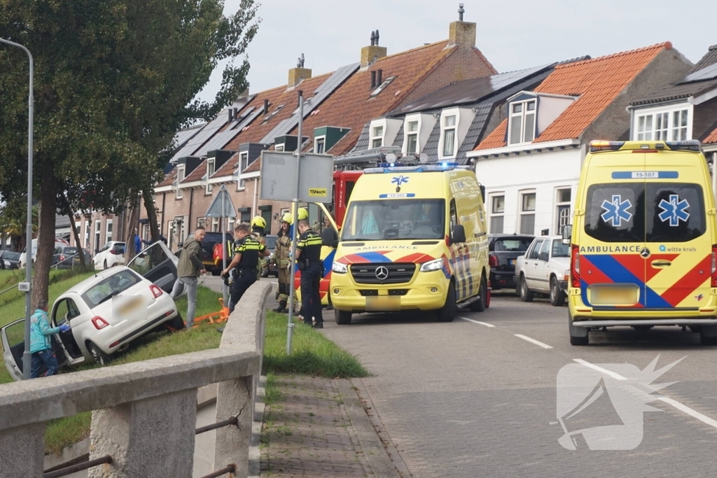 Auto van dijk gereden, bestuurder met spoed naar ziekenhuis