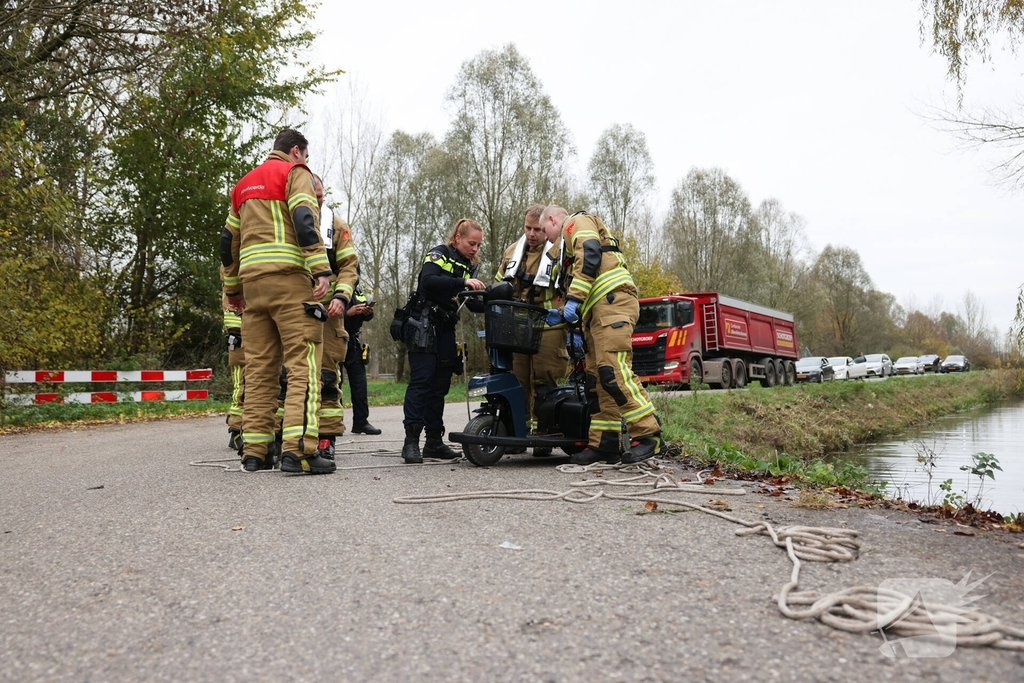 Man met scootmobiel te water