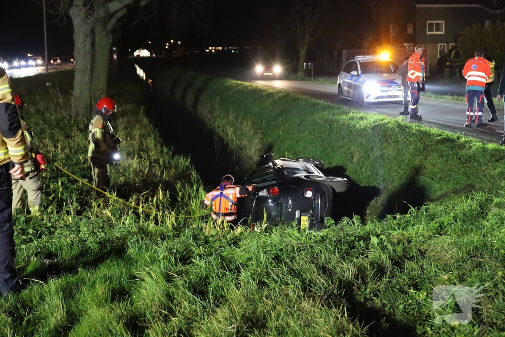 Auto belandt op zijkant in sloot