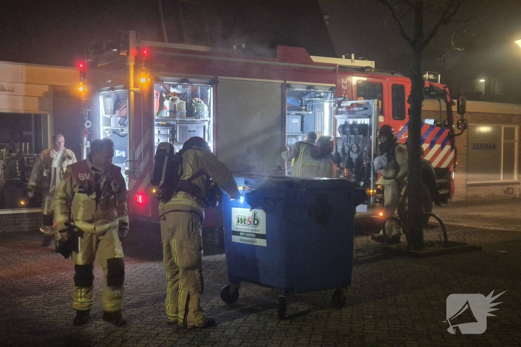 Brandweer dooft brand in papiercontainer