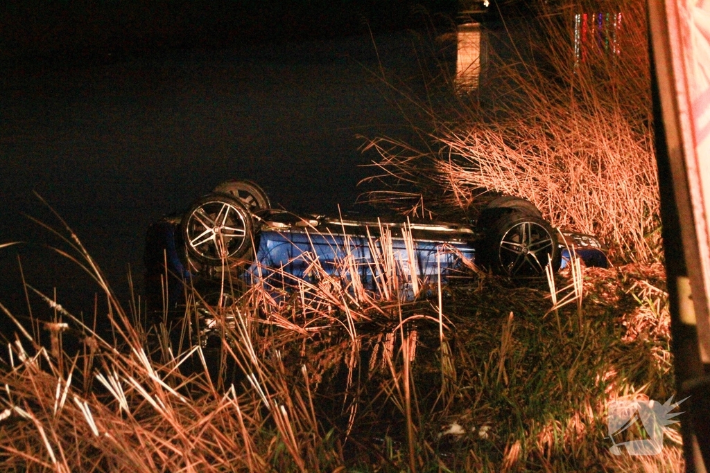 Auto belandt op de kop in het water