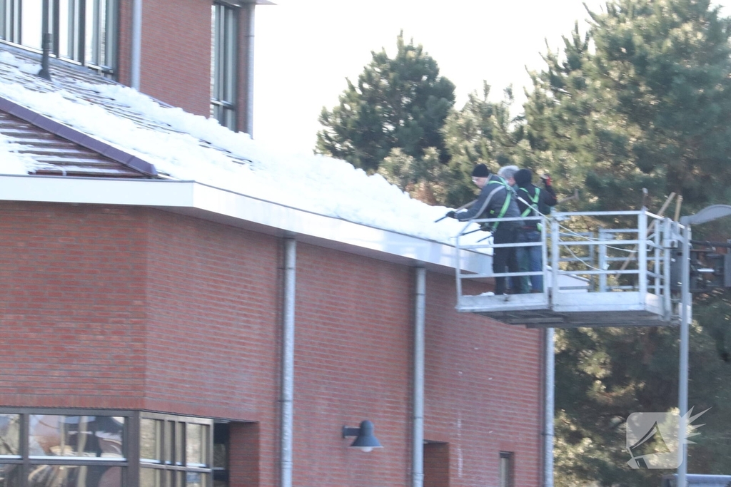 Dak van kerk sneeuwvrij gemaakt