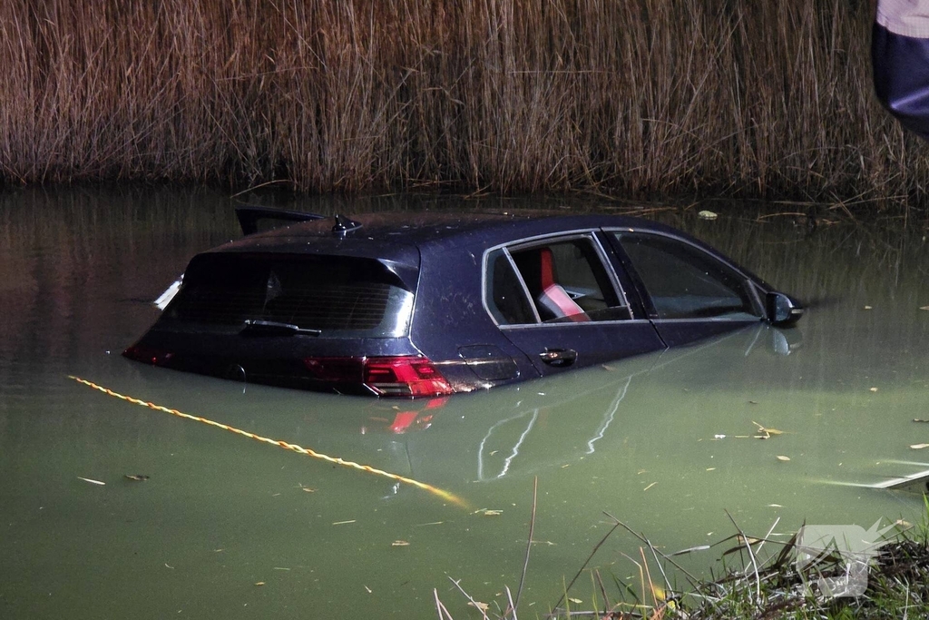 Auto belandt in water, brandweer doorzoekt water