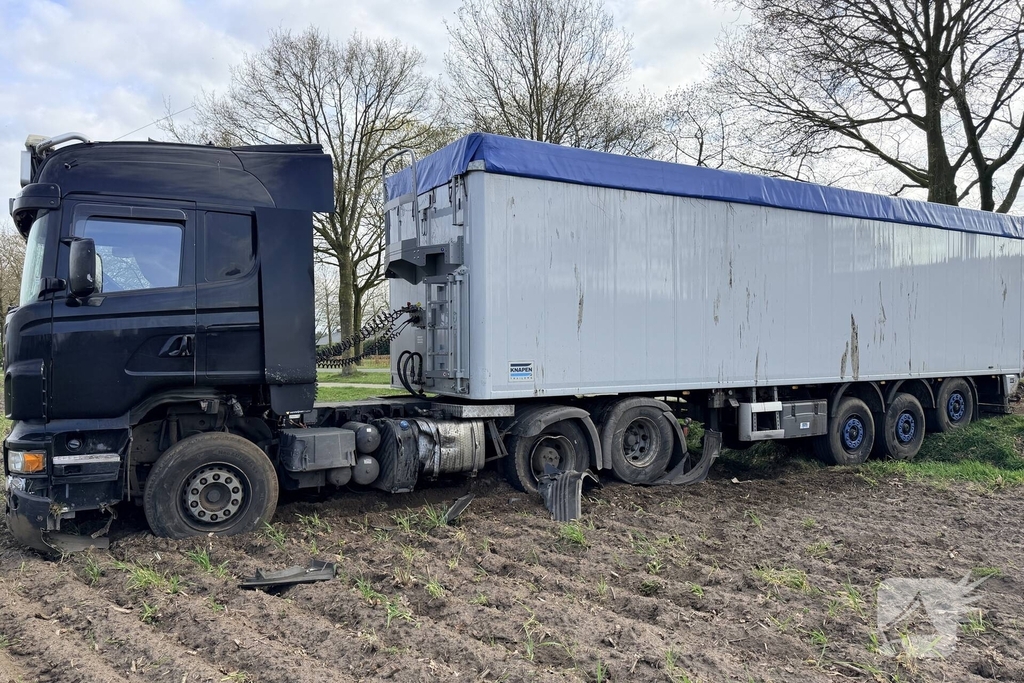 Vrachtwagen ramt auto en belandt in weiland