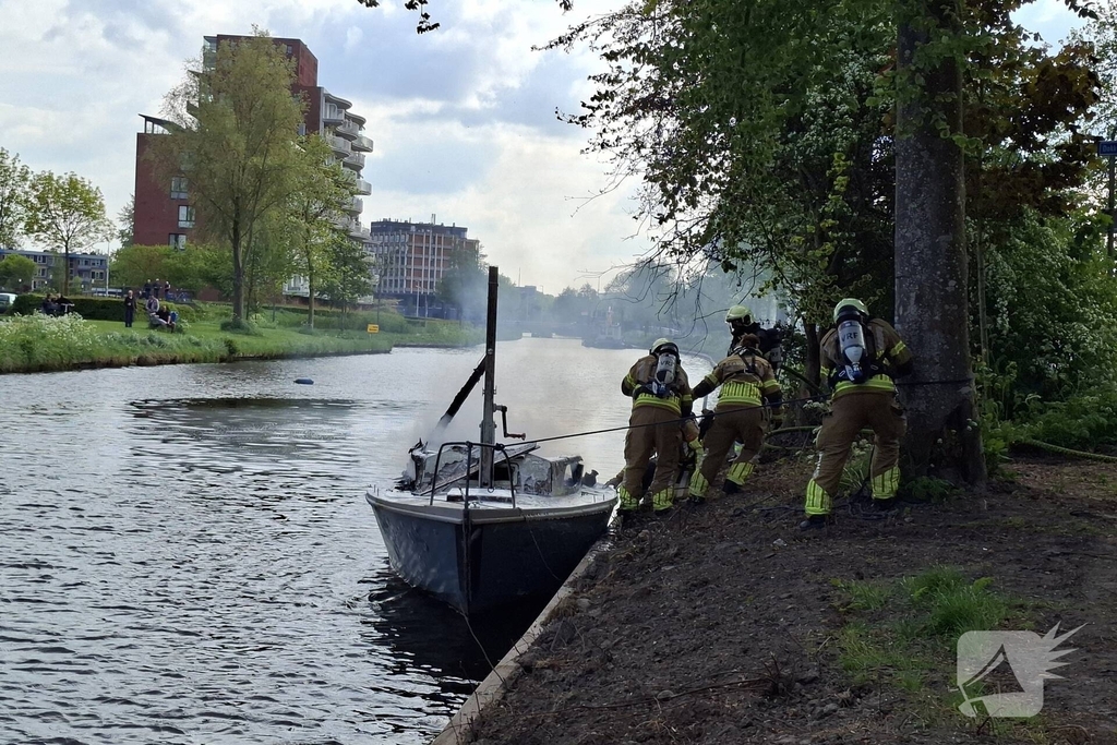 Brandweer blust felle brand op kleine zeilboot
