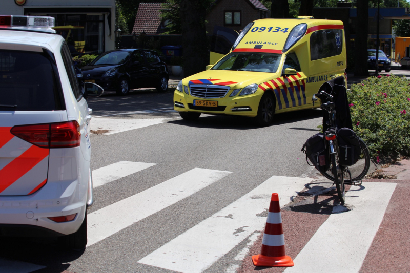 Fietser geschept door auto op rotonde