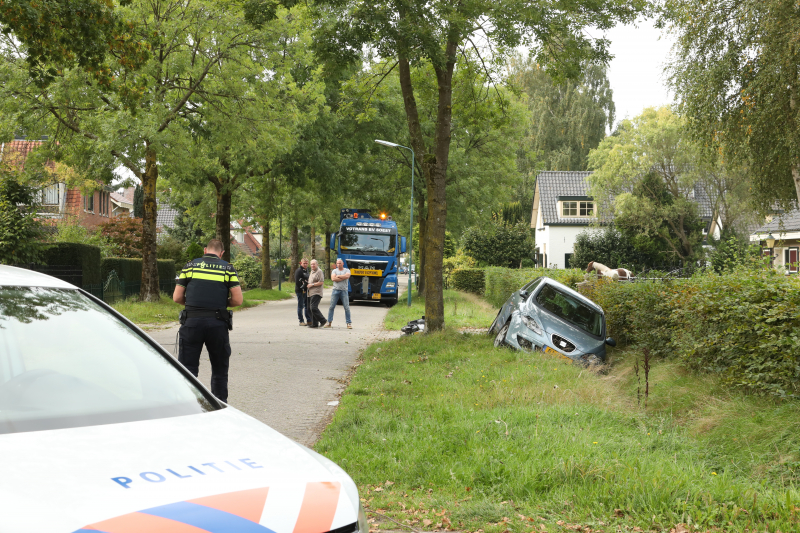 Auto belandt in droge sloot na botsing met brommer