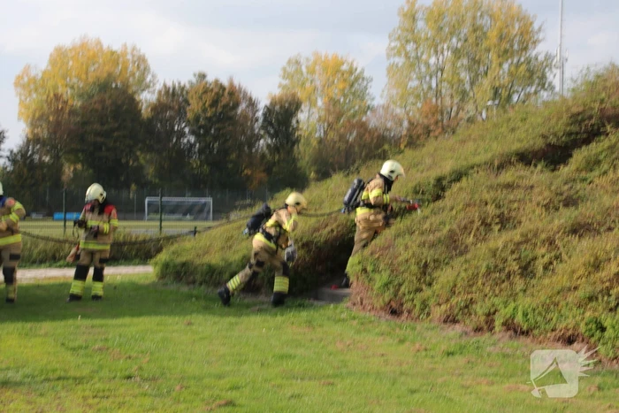 Groenstrook tegen sporthal in brand gestoken