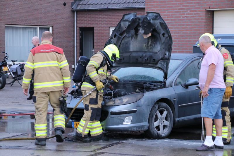 Auto vat vlam voor de garage