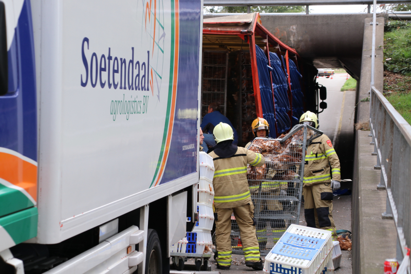 Vrachtwagen vol kippen vastgereden onder viaduct A30