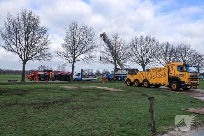 Kraanwagen belandt in weiland