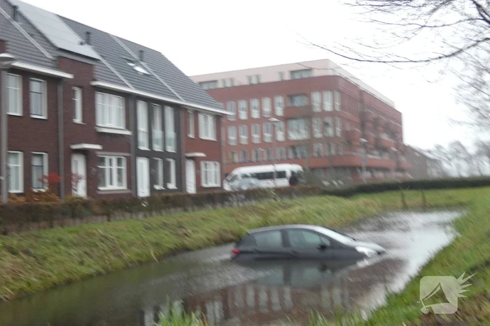 Auto achteruit de sloot in
