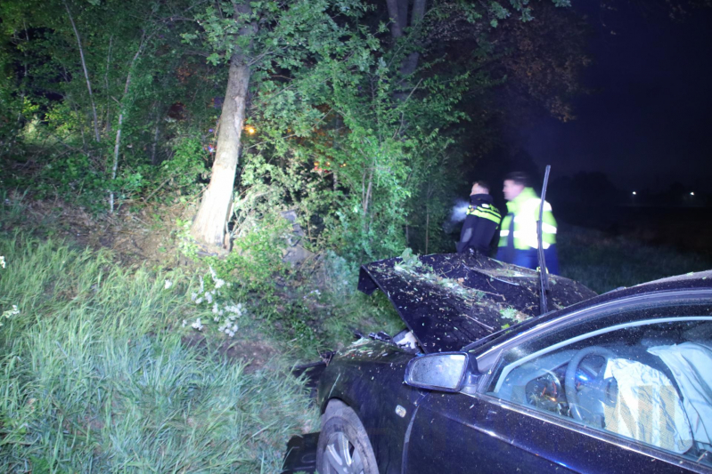 Auto belandt naast de snelweg