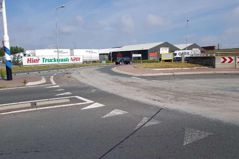 Weg afgesloten door bagger op wegdek