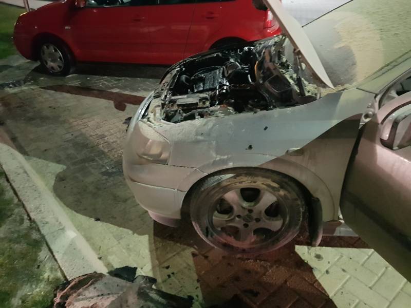 Omstanders blussen brandende auto